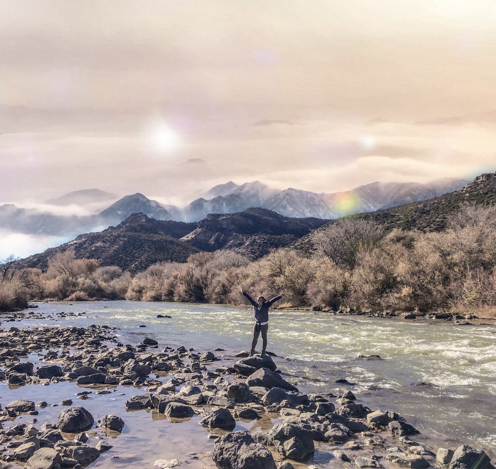 The author having fun on the rocks of the Rio Grande River in Northern New Mexico, depicting how she manages her High Sensation Seeker trait. 