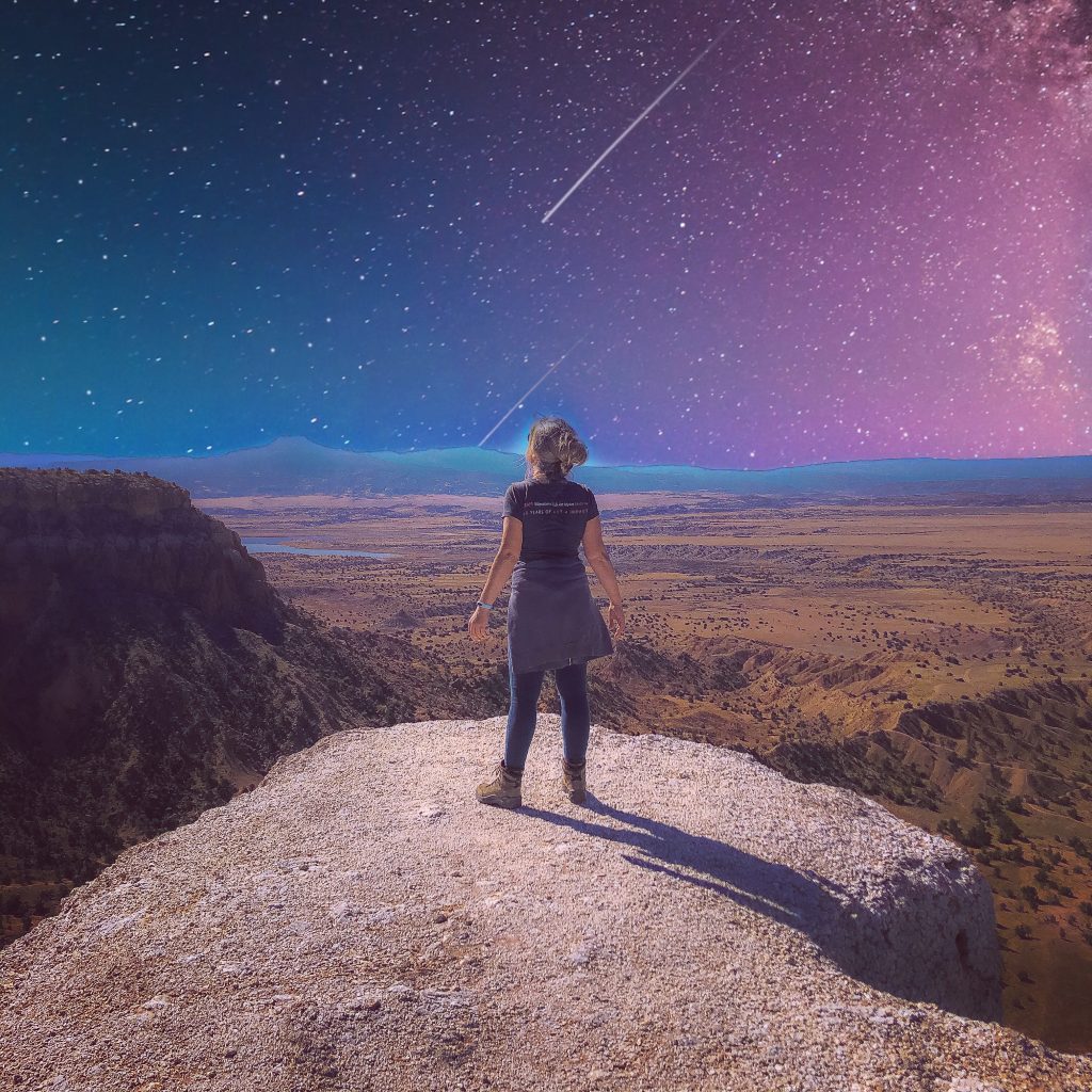 Kristy stands on the edge of an Abiquiu, New Mexico cliff, watching a shooting star. 
