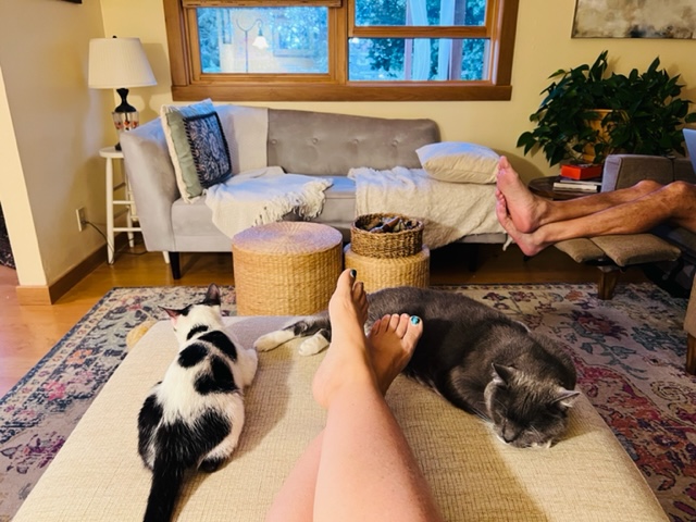 Kristy Sweetland lounging with her kitties